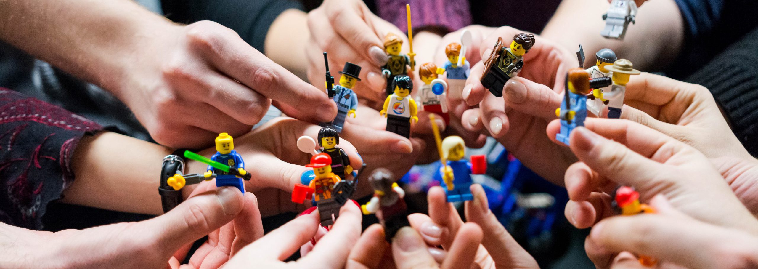 people holding miniature figures
